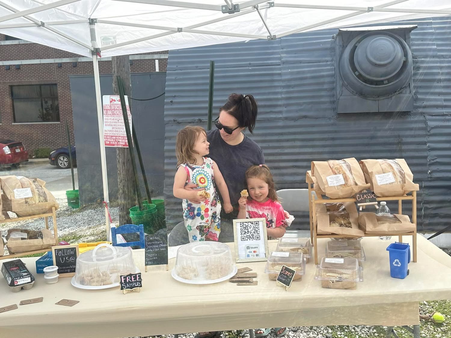 Reign & Wilder family market booth setup at a community event